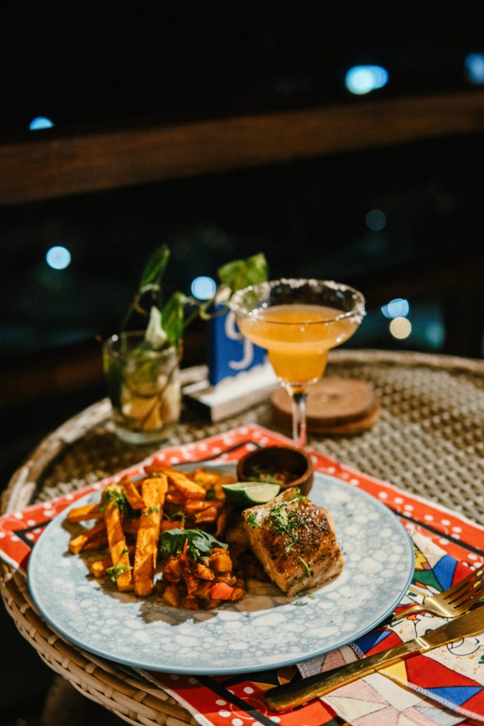 Chicken and chips on a plate with a beverage