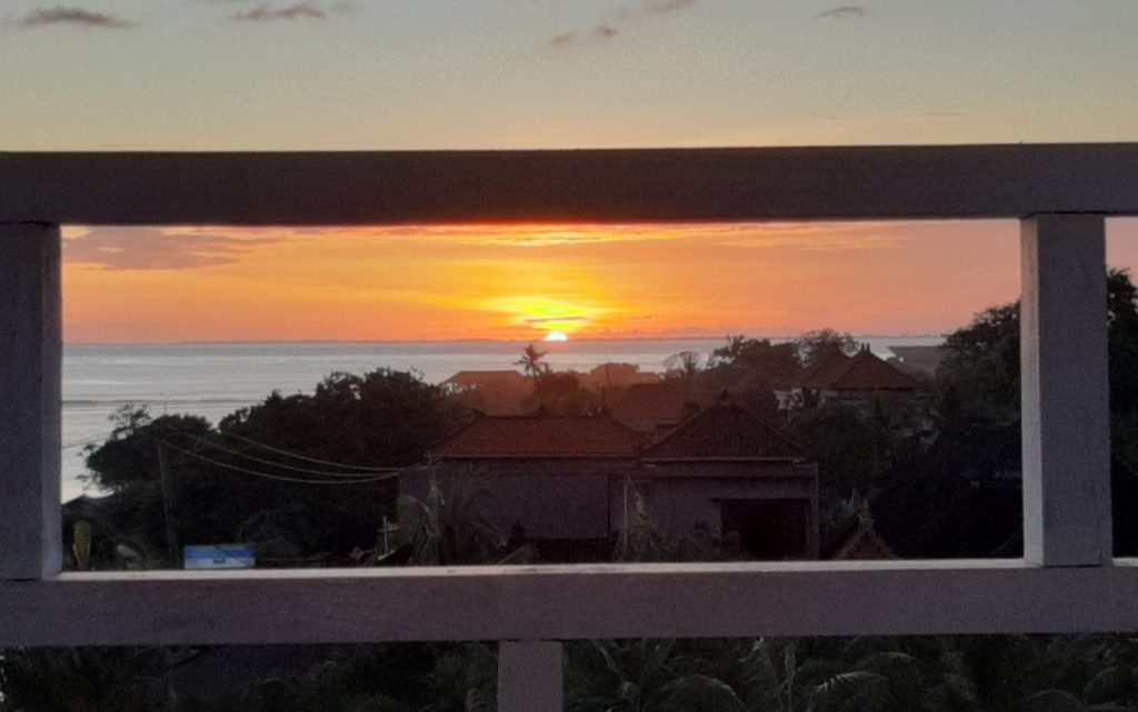 View of the sunset through white barricades 